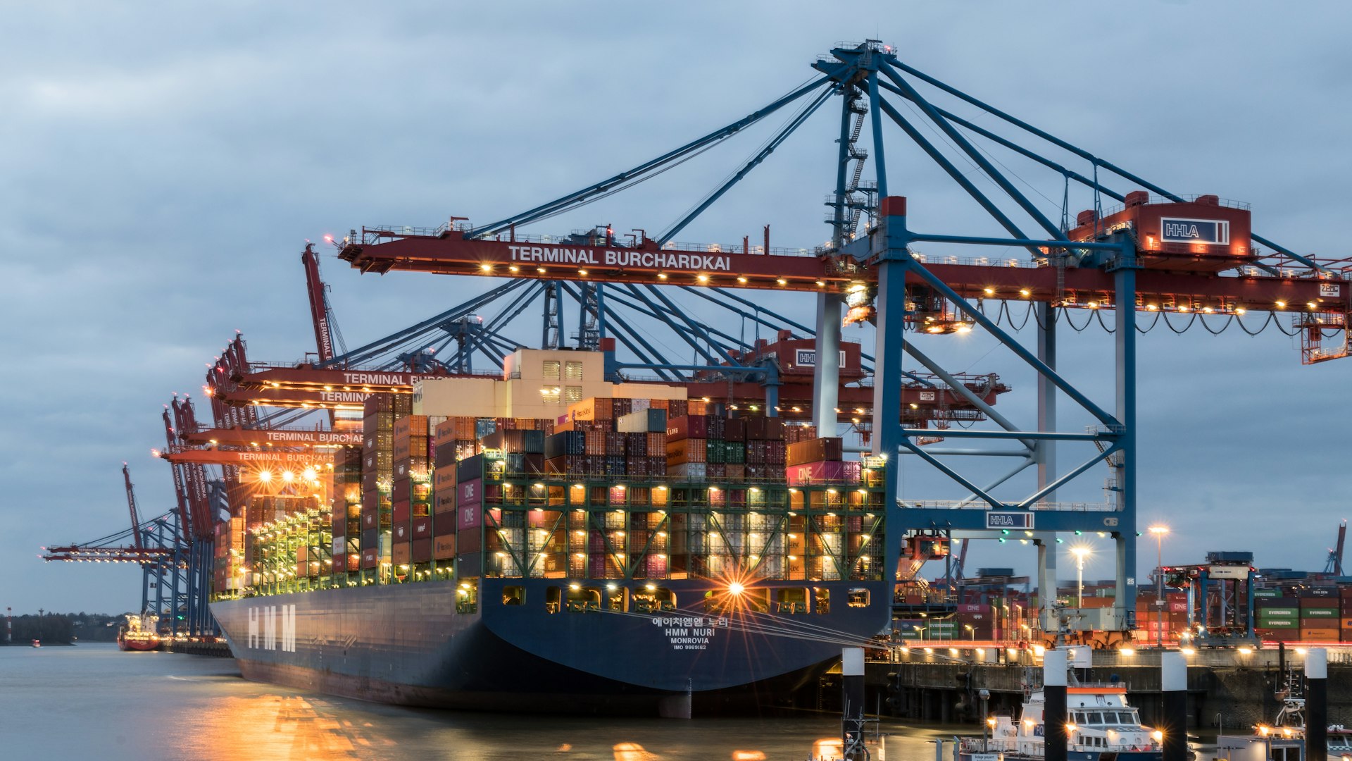 a large cargo ship in a harbor at night